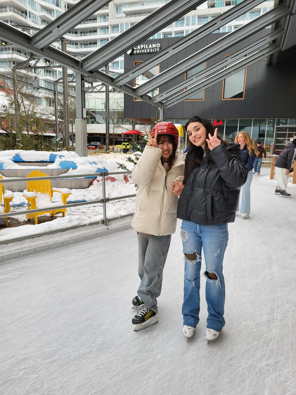 Two students posing whilst ice skating
