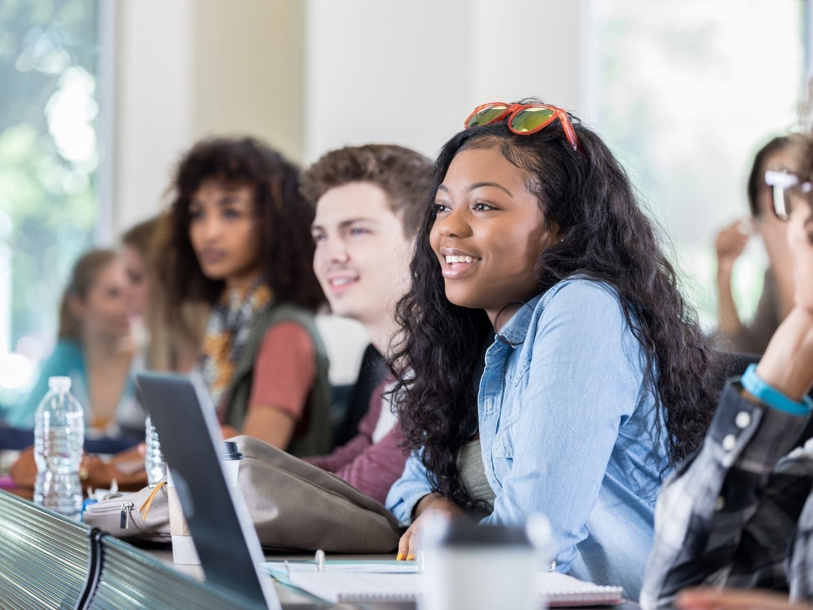 Students smiling and listening in the classroom