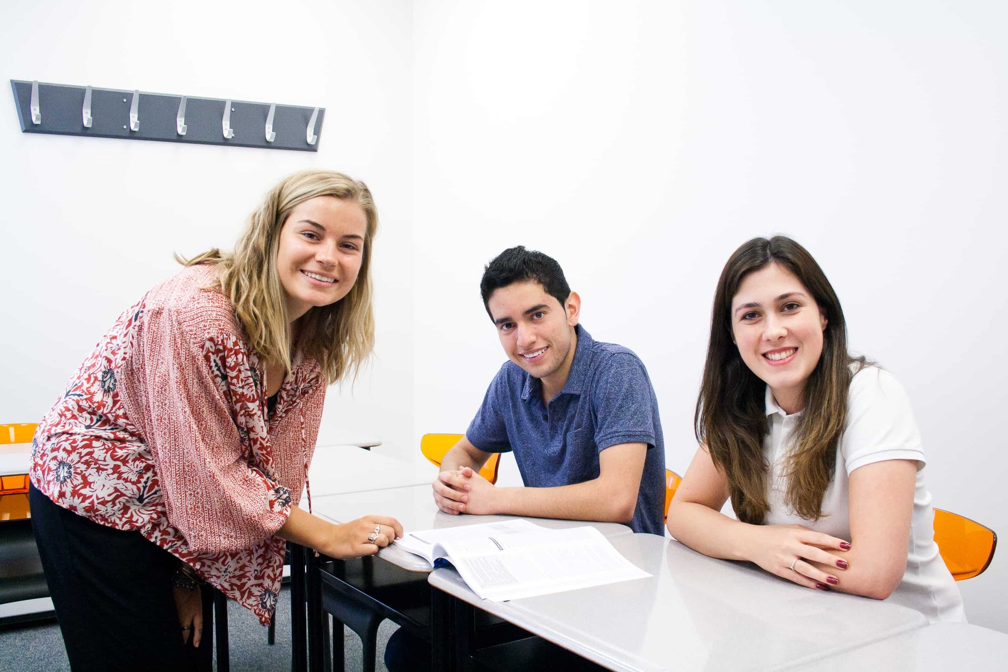 Teacher working with two students at a desk