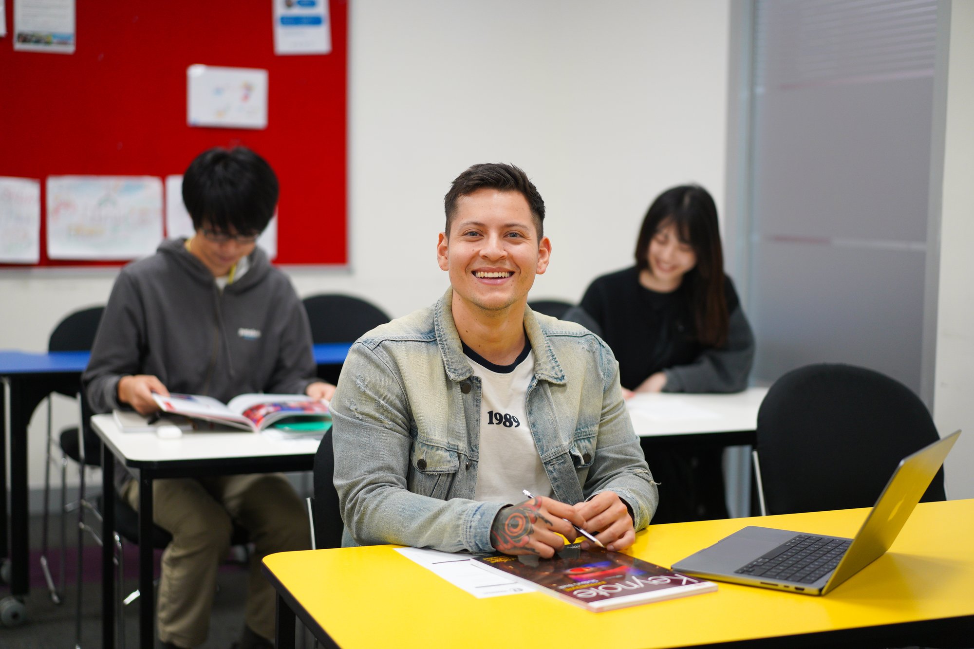 Student smiling at their desk