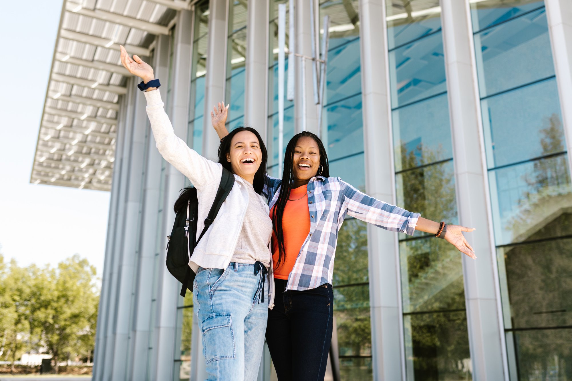 2 young women standing in front of a building